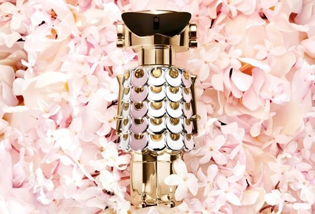 a bottle of perfume surrounded by pink petals background